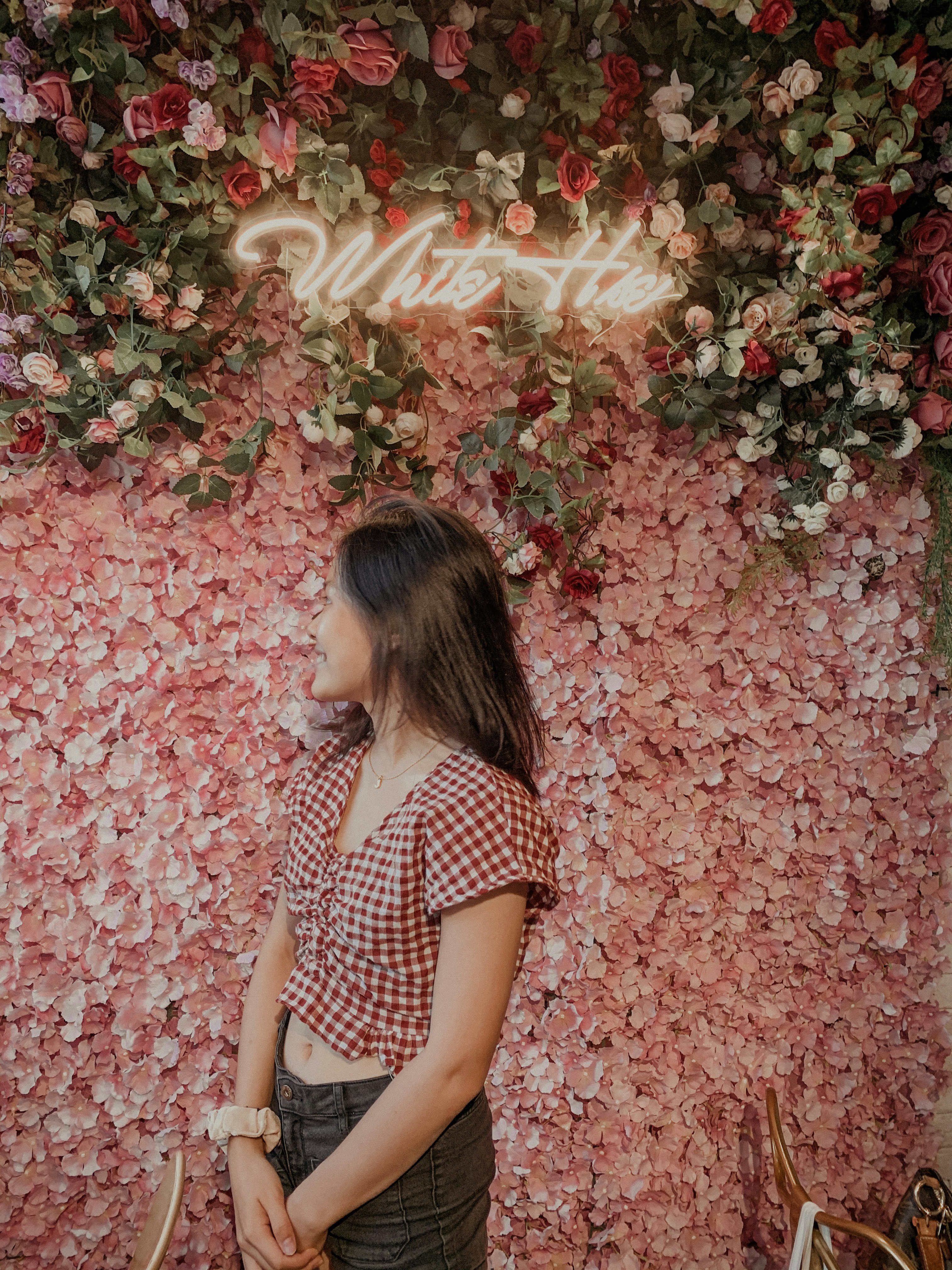 girl in black and white polka dot shirt standing on red leaves